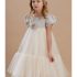 Elegant girl in ivory quinceanera dress with floral embellishments and tulle skirt.
