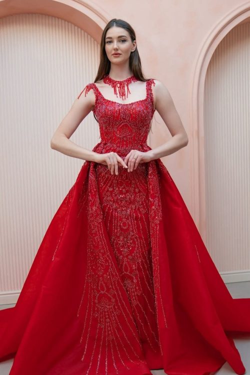 Sugar Land TX Custom Formal Gown - Model in a vibrant red beaded evening gown with a voluminous detachable overskirt.